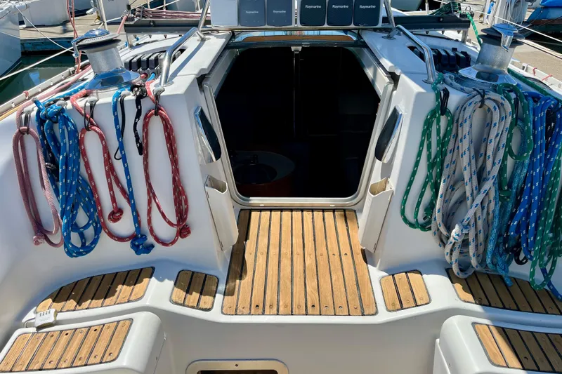 Marianne Yacht Photos Pics Cockpit of 1991 Beneteau First 38s5 sailboat with colorful ropes and wooden flooring.