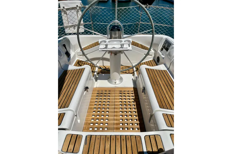 Marianne Yacht Photos Pics Cockpit of 1991 Beneteau First 38s5 sailboat with wooden seating and steering wheel.