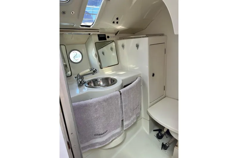 Marianne Yacht Photos Pics Bathroom interior of 1991 Beneteau First 38s5 yacht, featuring sink and mirror.