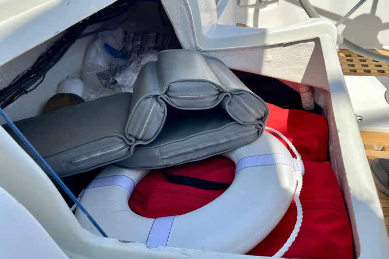 Marianne Yacht Photos Pics Storage compartment on a 1991 Beneteau First 38s5 with life preserver and cushions.