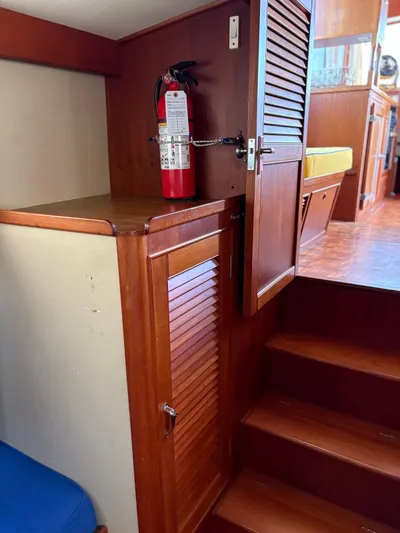  Yacht Photos Pics Interior of 1986 Grand Banks 36 Classic with wooden cabinetry and fire extinguisher.