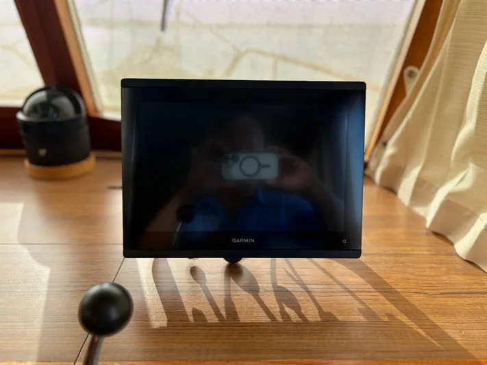  Yacht Photos Pics Garmin screen on 1986 Grand Banks 36 Classic boat dashboard, reflecting interior.