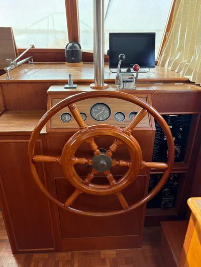  Yacht Photos Pics Wooden helm of 1986 Grand Banks 36 Classic yacht with gauges and controls.