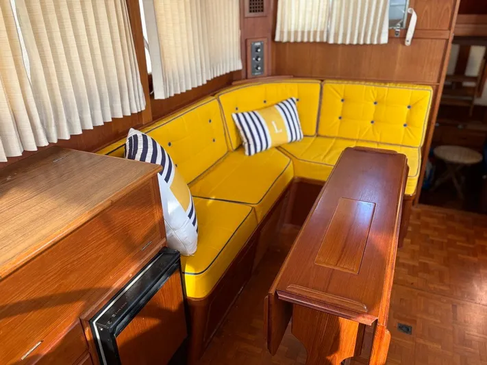  Yacht Photos Pics Interior of 1986 Grand Banks 36 Classic with yellow seating and wooden table.