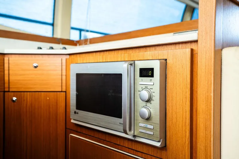  Yacht Photos Pics Microwave in 2009 Ferretti Yachts 470 kitchen, featuring wooden cabinetry and modern design.