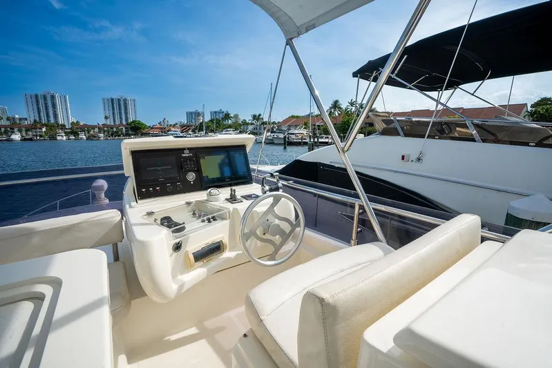  Yacht Photos Pics 2009 Ferretti Yachts 470 helm with waterfront view, featuring modern controls and seating.