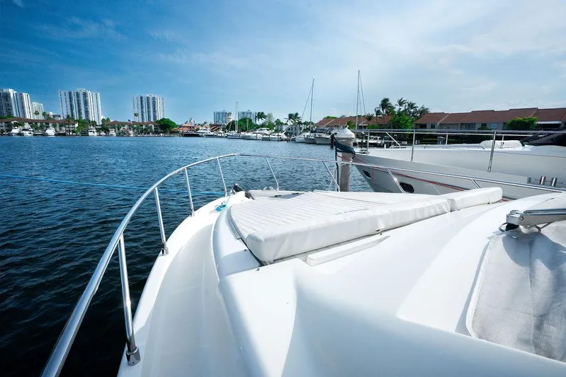  Yacht Photos Pics 2009 Ferretti Yachts 470 on calm water, city skyline in background.