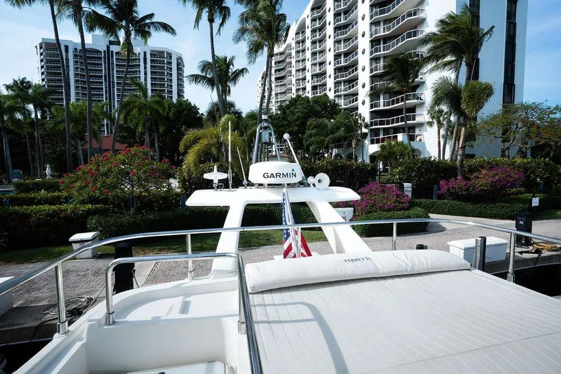  Yacht Photos Pics 2009 Ferretti Yachts 470 docked near modern high-rise buildings and palm trees.