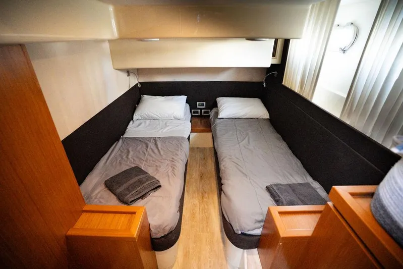  Yacht Photos Pics Twin cabin interior of 2009 Ferretti Yachts 470 with modern design and cozy bedding.