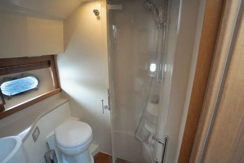  Yacht Photos Pics Luxurious bathroom in 2009 Ferretti Yachts 470 with shower and porthole view.