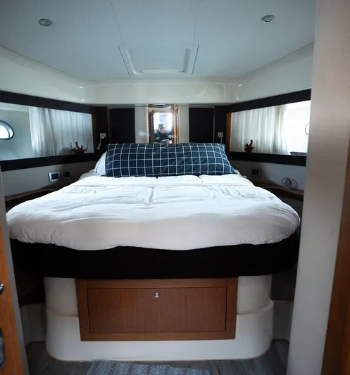  Yacht Photos Pics Luxurious bedroom interior of a 2009 Ferretti Yachts 470 with a large bed.