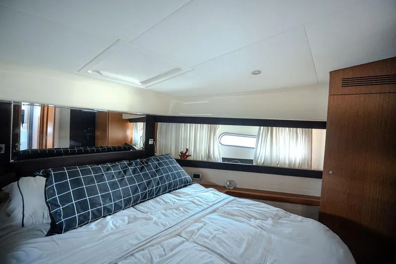  Yacht Photos Pics Luxurious bedroom interior of 2009 Ferretti Yachts 470 with elegant bedding and window view.