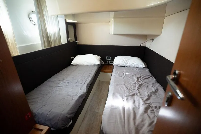  Yacht Photos Pics Twin cabin interior of 2009 Ferretti Yachts 470 with modern design and cozy bedding.