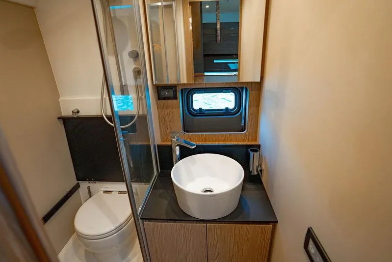 Relax Josephine Yacht Photos Pics Luxurious bathroom in 2022 Azimut Atlantis 45 yacht with modern fixtures and porthole window.