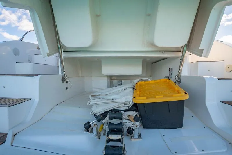 Relax Josephine Yacht Photos Pics Storage compartment of 2022 Azimut Atlantis 45 yacht with equipment and yellow-lidded container.