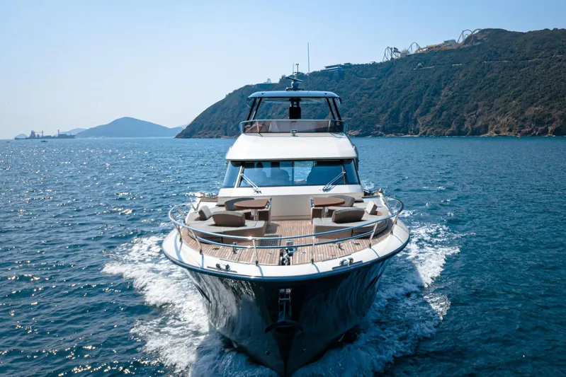 Mcy 70 Hk Yacht Photos Pics 2014 Monte Carlo Yachts MCY 70 cruising on open water near scenic coastline.