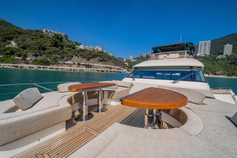 Mcy 70 Hk Yacht Photos Pics Luxurious 2014 Monte Carlo Yachts MCY 70 with elegant deck seating and scenic coastal backdrop.