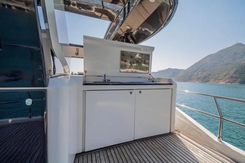 Mcy 70 Hk Yacht Photos Pics Outdoor kitchen on 2014 Monte Carlo Yachts MCY 70, with ocean and mountain view.