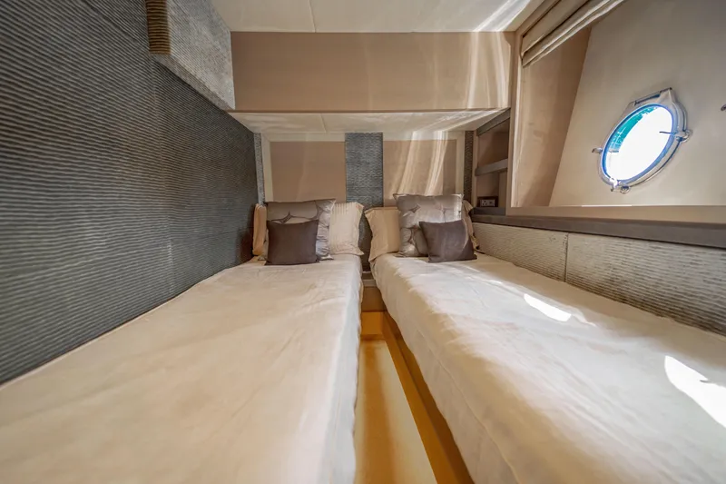 Mcy 70 Hk Yacht Photos Pics Luxurious twin cabin interior of 2014 Monte Carlo Yachts MCY 70 with porthole view.