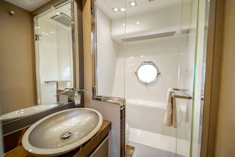 Mcy 70 Hk Yacht Photos Pics Luxurious bathroom on 2014 Monte Carlo Yachts MCY 70, featuring modern sink and porthole window.