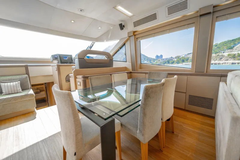 Mcy 70 Hk Yacht Photos Pics Luxurious interior of 2014 Monte Carlo Yachts MCY 70 with elegant dining area and scenic views.