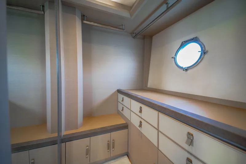 Mcy 70 Hk Yacht Photos Pics Luxurious interior of 2014 Monte Carlo Yachts MCY 70 with elegant cabinetry and porthole window.