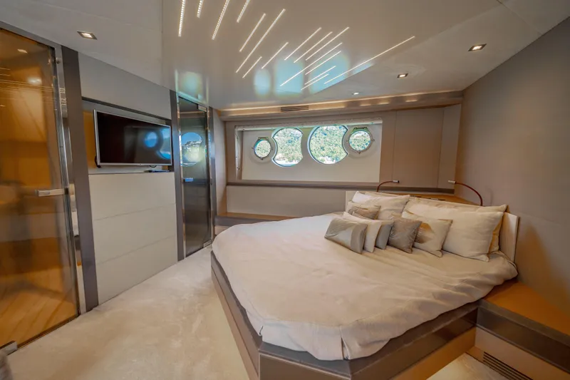 Mcy 70 Hk Yacht Photos Pics Luxurious bedroom interior of 2014 Monte Carlo Yachts MCY 70 with modern design and circular windows.