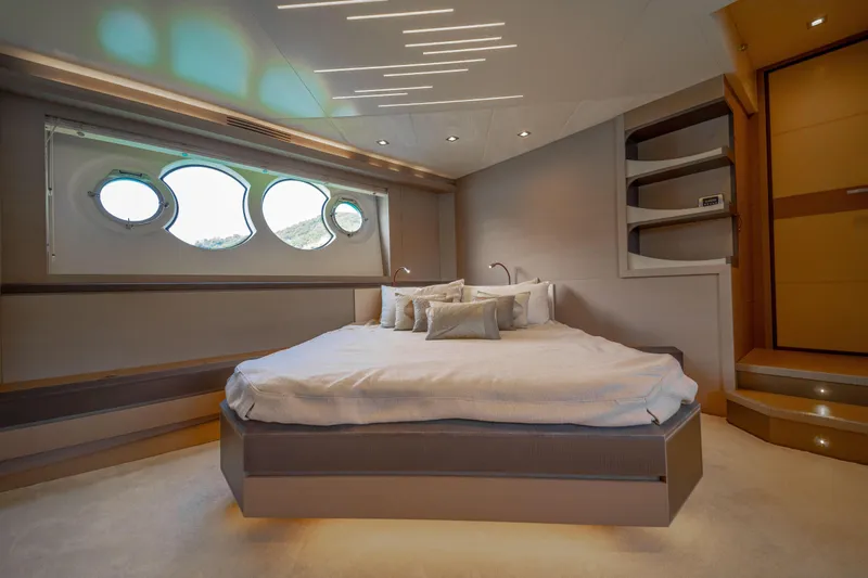 Mcy 70 Hk Yacht Photos Pics Luxurious bedroom interior of 2014 Monte Carlo Yachts MCY 70 with modern design and porthole windows.