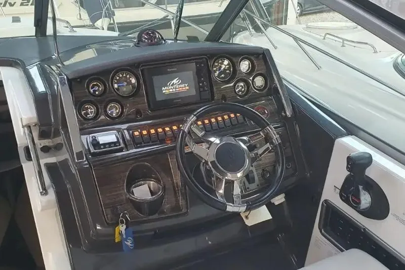  Yacht Photos Pics Cockpit of 2017 Monterey 295 Sport Yacht with modern controls and steering wheel.