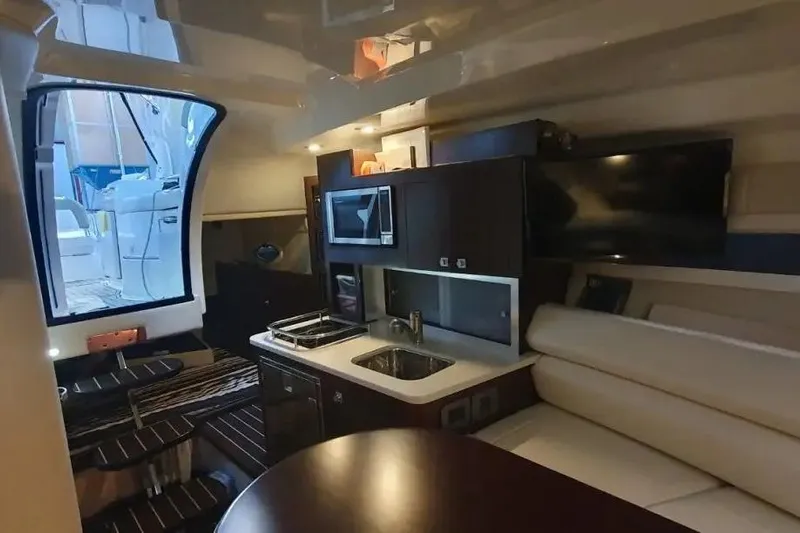  Yacht Photos Pics Interior of 2017 Monterey 295 Sport Yacht with kitchenette and seating area.