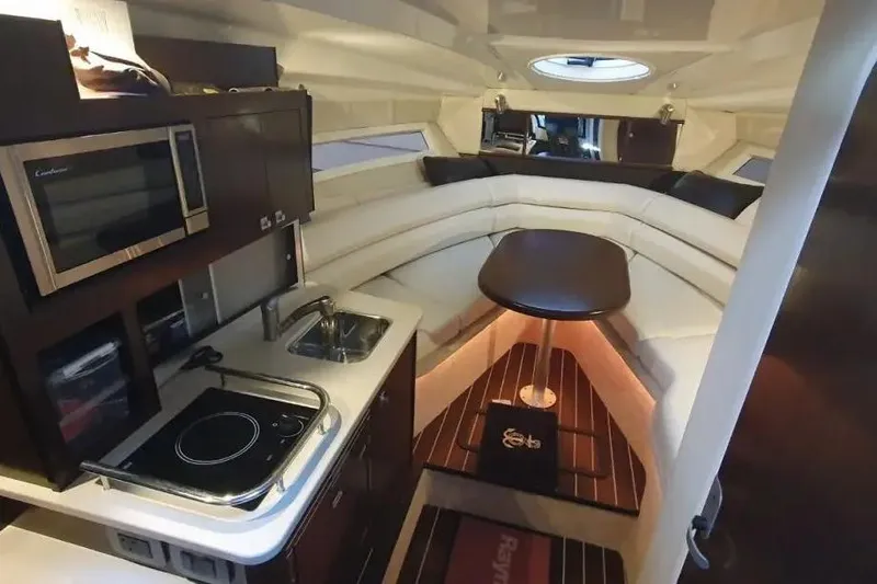  Yacht Photos Pics Interior of 2017 Monterey 295 Sport Yacht with kitchenette and seating area.