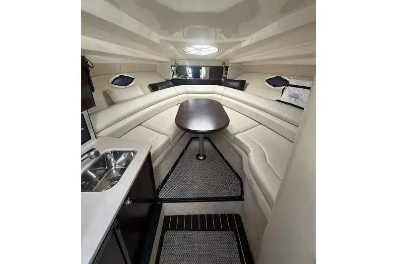  Yacht Photos Pics Interior of 2017 Monterey 295 Sport Yacht with seating, table, and kitchenette.