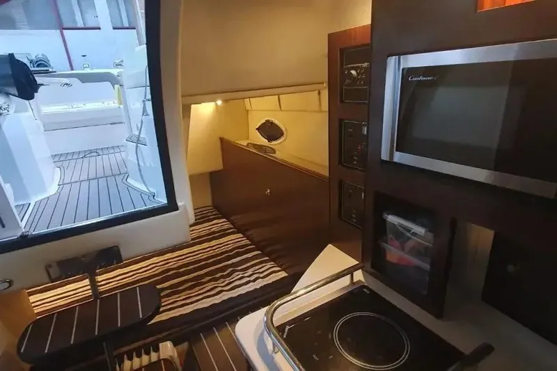  Yacht Photos Pics Interior of 2017 Monterey 295 Sport Yacht with kitchenette and cozy sleeping area.