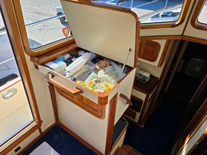 Lindy Yacht Photos Pics Interior of 2004 Legacy Sedan Flybridge with open storage compartment and various items.
