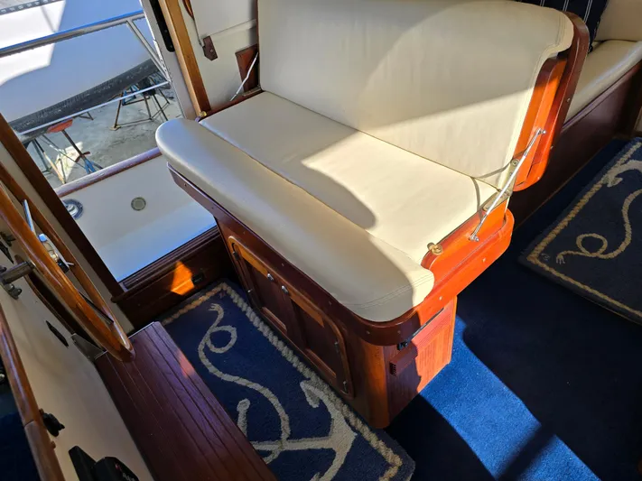 Lindy Yacht Photos Pics Interior of 2004 Legacy Sedan Flybridge with wooden accents and cushioned seating.