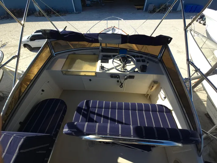 Lindy Yacht Photos Pics 2004 Legacy Sedan Flybridge cockpit with striped seating and steering wheel.