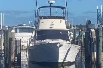 Lindy Yacht Photos Pics 2004 Legacy Sedan Flybridge boat docked at marina under clear blue sky.