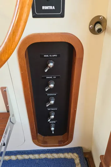 Lindy Yacht Photos Pics Control panel with switches in a 2004 Legacy Sedan Flybridge boat interior.