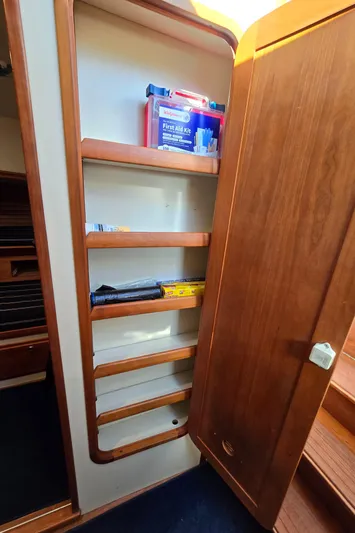 Lindy Yacht Photos Pics Wooden storage shelves inside a 2004 Legacy Sedan Flybridge boat.