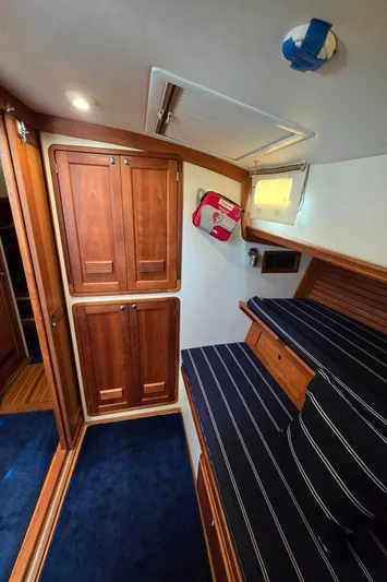 Lindy Yacht Photos Pics Interior of 2004 Legacy Sedan Flybridge with wooden cabinets and striped seating.