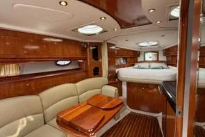  Yacht Photos Pics Luxurious interior of 2008 Four Winns V358 yacht with elegant wood finishes and plush seating.