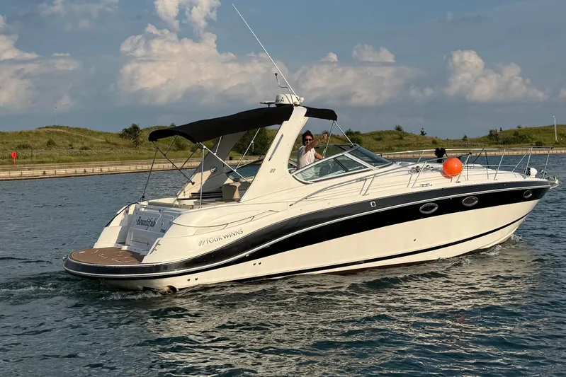  Yacht Photos Pics 2008 Four Winns V358 boat cruising on a sunny day with scenic background.