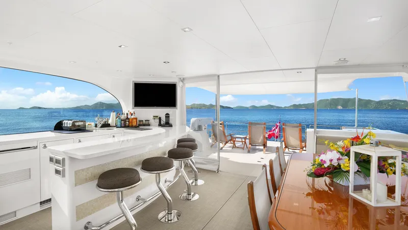 Sea Glass Yacht Photos Pics Luxurious Horizon PC74 yacht interior with bar, dining area, and ocean view.