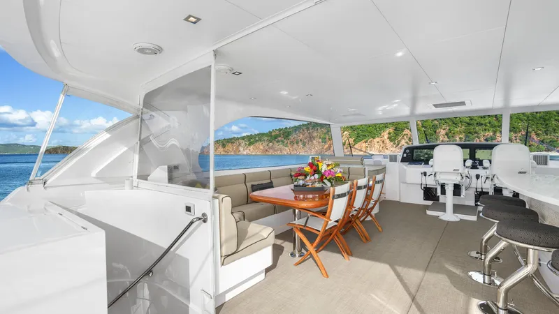 Sea Glass Yacht Photos Pics Luxurious Horizon PC74 yacht deck with dining area, ocean view, and modern seating, 2018 model.