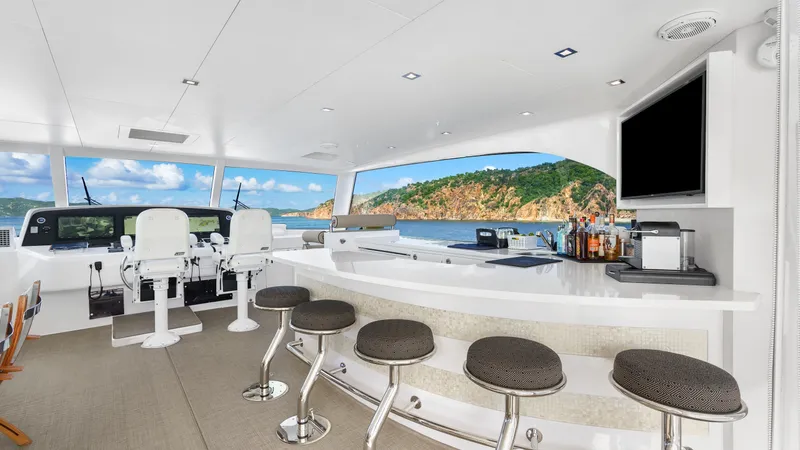 Sea Glass Yacht Photos Pics Luxurious Horizon PC74 yacht interior with bar, stools, and scenic ocean view, 2018 model.