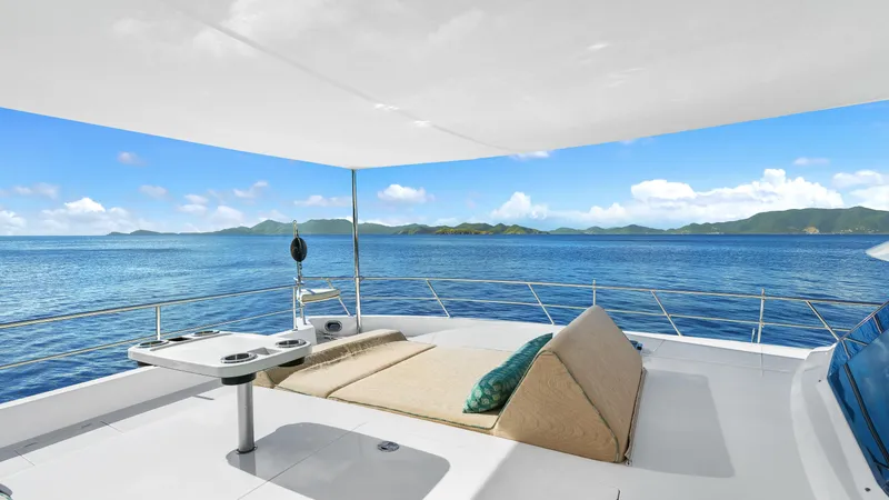 Sea Glass Yacht Photos Pics Luxurious Horizon PC74 yacht deck with sunbed, ocean view, and canopy, 2018 model.