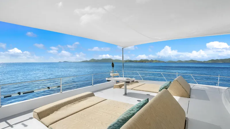 Sea Glass Yacht Photos Pics Luxurious Horizon PC74 yacht deck with sun loungers, ocean view, and canopy, 2018 model.