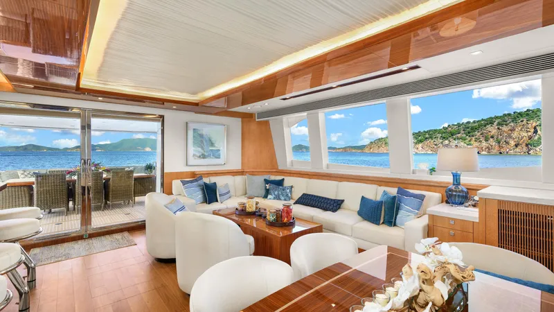 Sea Glass Yacht Photos Pics Luxurious yacht interior with ocean view, featuring elegant seating and dining area. Horizon PC74, 2018.