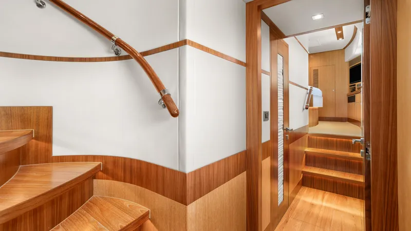 Sea Glass Yacht Photos Pics Luxurious wooden interior of 2018 Horizon PC74 yacht, featuring elegant stairs and modern design.