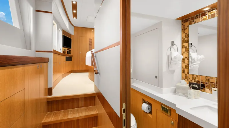 Sea Glass Yacht Photos Pics Luxurious interior of 2018 Horizon PC74 yacht featuring wooden stairs and modern bathroom.